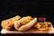 Fully loaded hot dogs and potato wedges on wooden board