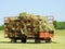 Fully loaded red hay wagon with square haybales