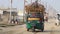 A fully loaded three wheeler auto rickshaw tempo moving on the road.