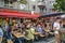 Fully occupied tables and chairs at a street festival. Guests eating and drinking in a restaurant in the center of Berlin