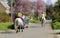Fulwell Road, Finmere, Oxfordshire, United Kingdom, March 26, 2017: Female riders and horses on village road wearing Please Pass