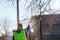 Fumigating pesti, pest control. Defocus farmer woman spraying tree with green pesticide sprayer against insects in