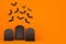 Fun cemetery - halloween orange background with blank black sale labels and bats flock, mock up.