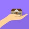 Fun cool house in hand with shadow. Flat design