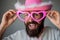 Fun cowboy. Happy man with funny pink glasses smile face closeup. Handsome smiling young guy. Positive human facial