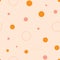 Fun dots and circles seamless repeat pattern. Hand-drawn dots and circles in different sizes and in eart tones, vector