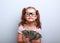 Fun emotional small kid girl in glasses holding and showing doll