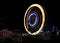 Fun fair Giant Colorful Ferris wheel spinning at night. Slow shutter image of a rotating giant wheel at night