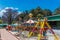 Fun fair rides by a lake side, beautiful tress in the background, Ooty, India, 19 Aug 2016