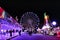 Fun fairground attractions at night in Elche