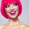 Fun fashion model with bright make-up.  Laughing Model with creative colored bob hairstyle