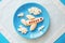 Fun food idea for kids. children`s Breakfast: plane made of banana and clouds made of curd on a blue plate