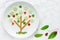 Fun food, vegetables snack plate shaped green tree, springtime and love theme food art