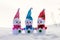 Fun and friendly company of three toy snowmen in the snow_