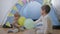 Fun games, cheerful friendly brothers enjoy spending time together playing balloons