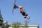 Fun jumping, skiing. Young boy, the skier, doing somersaults high in the blue sky with skis