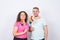 Fun man and woman standing with rainbow flags, lgbt concept