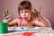 Fun pastime and art concept. Colorful painted hands in a beautiful young girl. Horizontal image