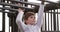 Fun and playful boy playing on monkey bars, jungle gym or playground in park, home garden or backyard. Adorable, cute