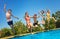 Fun in the pool group of kids jump inside water