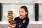 fun portrait of a smiling girl with her stack of donuts in balance