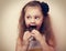 Fun surprising kid girl eating dark chocolate. Vintage closeup