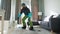 Fun video. Man dressed as a snowboarder rides a snowboard on a carpet in a cozy room. Waiting for a snowy winter