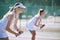 Fun women playing tennis match, practicing for competition and getting ready for sporty fitness game on a court outside