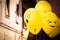 Fun yellow Emoji balloons floating at a street party