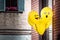 Fun yellow Emoji balloons floating at a street party