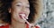 Fun young woman biting Christmas candy cane