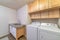 Functional laundry room with appliances and double basin sink and cabinets