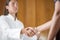 Functional medicine practicioner shaking hands with a client