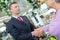 Funeral director shaking hands with elderly woman