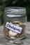 Funeral financing concept with jar coins closeup