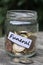 Funeral financing concept with jar coins closeup