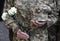 A funerals of Ukrainian servicemen killed during Russia`s invasion of Ukraine. Soldier holds flowers