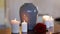 Funerary urn and candles on table burning indoors