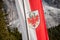 FUNES, ITALY - SEPTEMBER 22, 2017: The red and white Alto Adige regional flag is on the wind in all mountain refuge like tradition