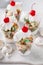 Funfetti cake trifle with meringue kisses and a cherry on top