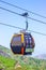 Funicular or cable car for tourists on green mountains and blue sky background in summer.