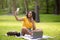 Funky black girl with laptop taking selfie while studying at park