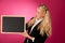 Funky business woman holding a blank blackboard - teacher