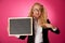 Funky business woman holding a blank blackboard - teacher