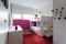 Funky kids bedroom with red carpet and pink painted wall