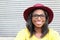 Funky style beauty. Portrait of beautiful young African woman in glasses and funky hat smiling