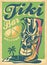 Funky Tiki mask mascot with sunglasses advertising tropical cafe bar