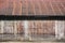 Funky wooden building with rusty corrugated metal roof in rural Laos