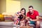 Funky young couple eating pizza on a couch