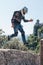 Funn jump with happines. Man dressed in a motorcycle outfit and white helmet. body protection turtle and knee pads. Fortress on